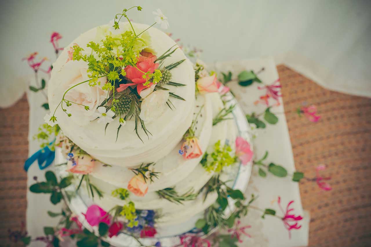 PJ and Nick wedding cake with flower decor