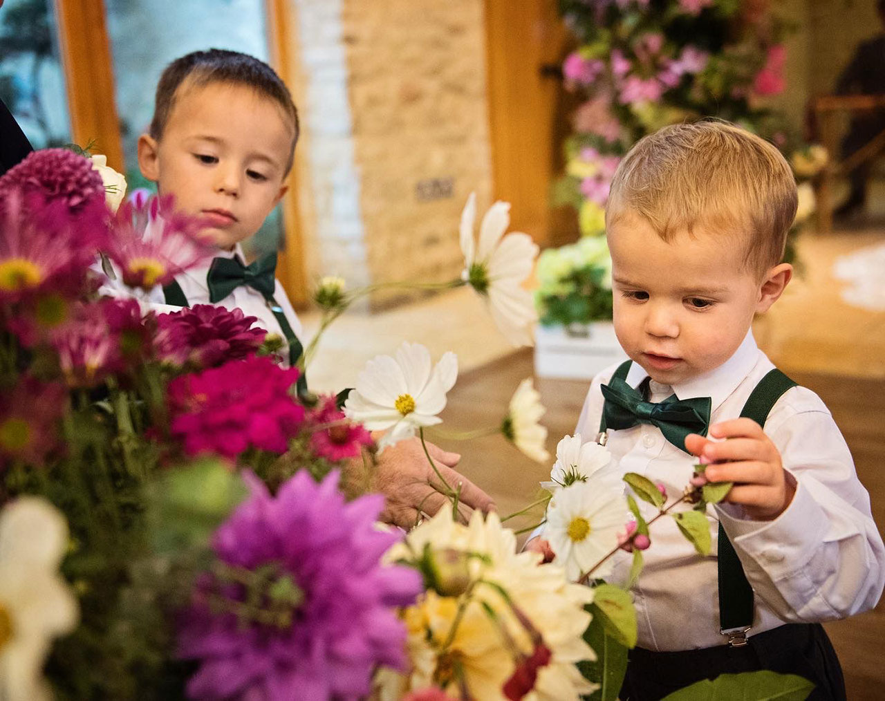 Page boys fascinated by wedding flowers