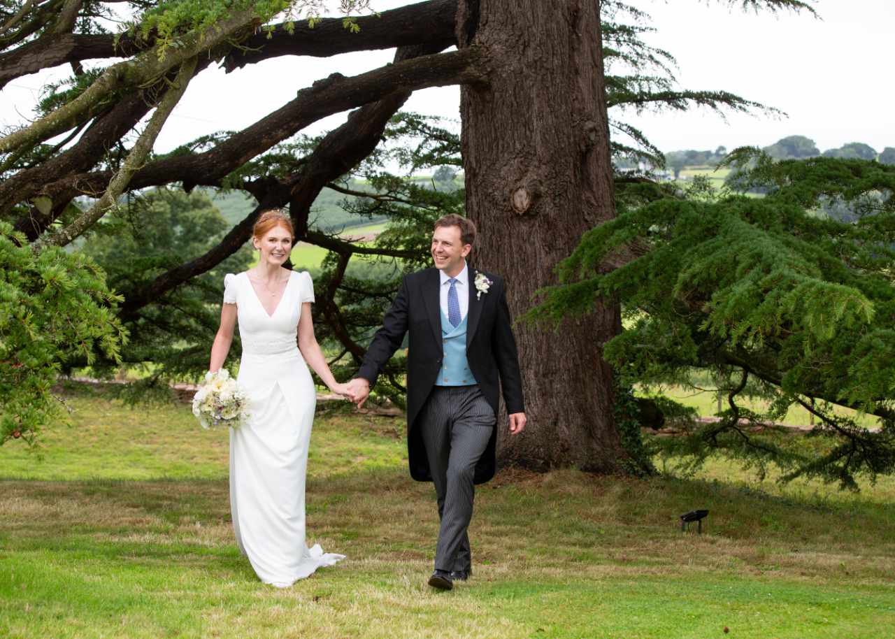 Happy bride and groom under tree