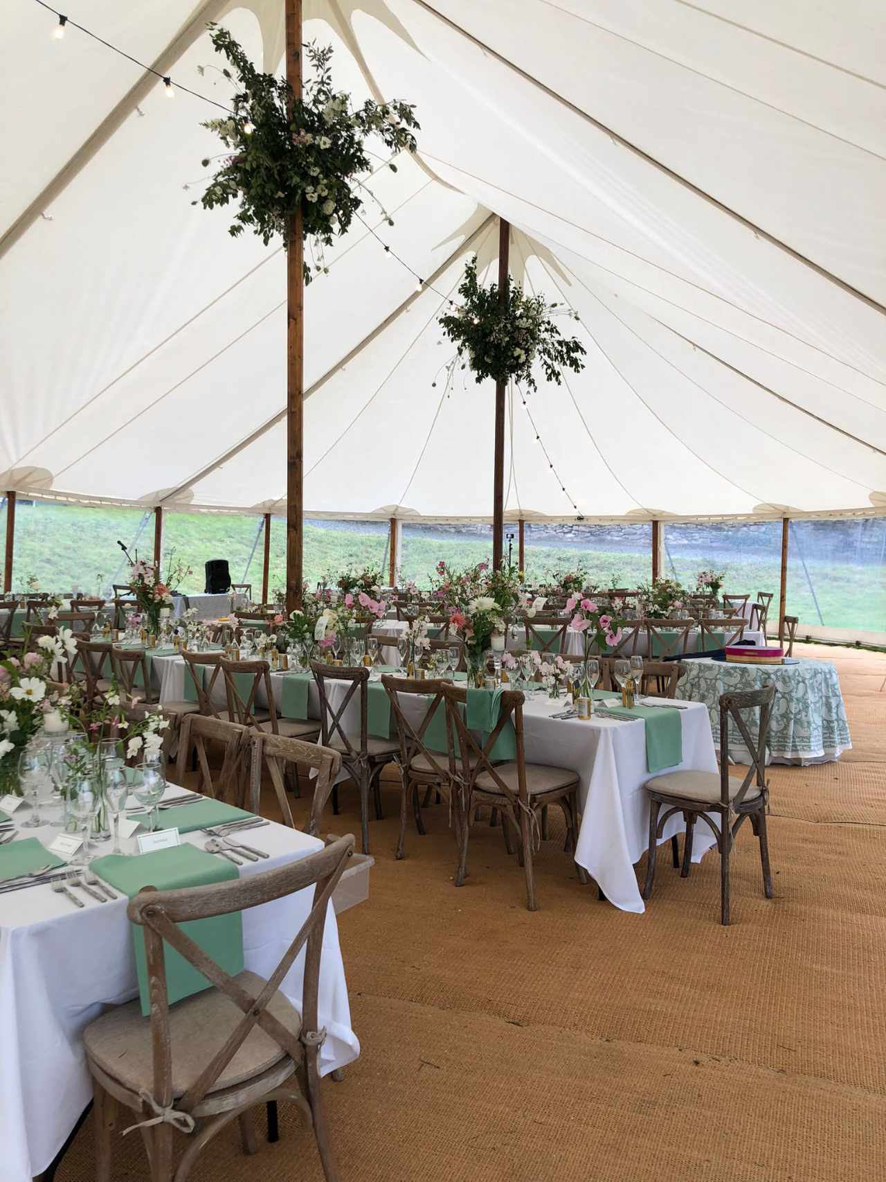 Wedding marquee with greenery, flowers and flower clouds