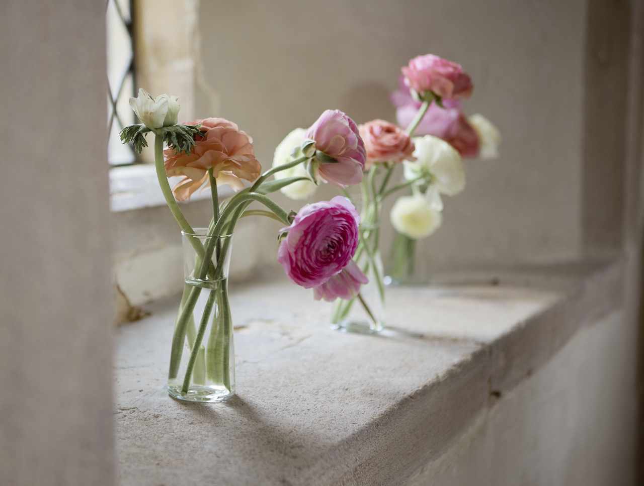 Wedding flower vases on a stone sil