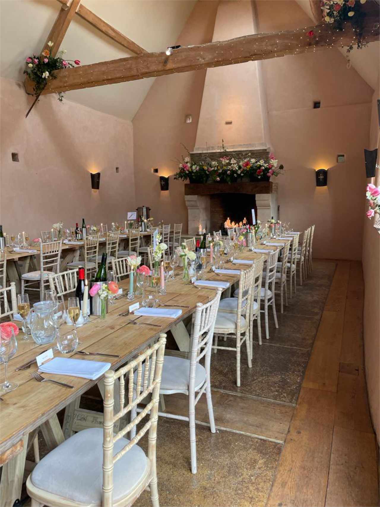 Oxleaze barn wedding with table flowers and mantle flowers